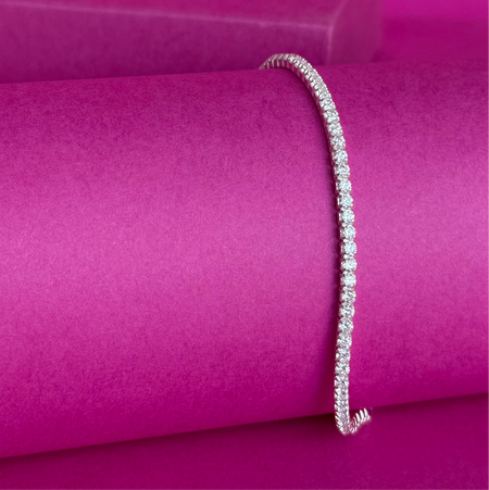925 Sterling Silver tennis bracelet with silver cubic zirconia inlay on a pink background, size adjustable for a perfect fit.