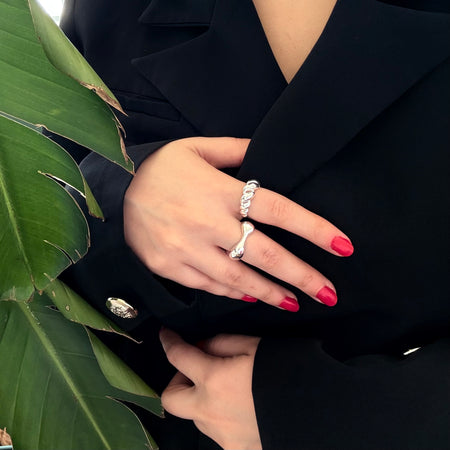 Mia Rings in 925 sterling silver, showcasing geometric design and adjustable fit, elegantly worn with red nail polish.
