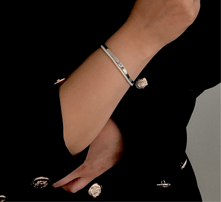 925 Sterling Silver tennis bracelet with cubic zirconia inlay, adjustable size, worn on wrist against black fabric.